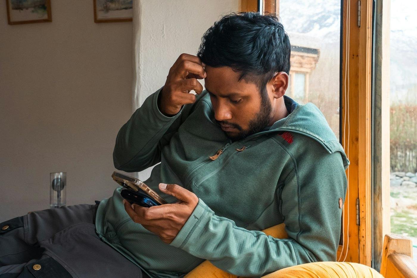 Man looking puzzled at his smartphone