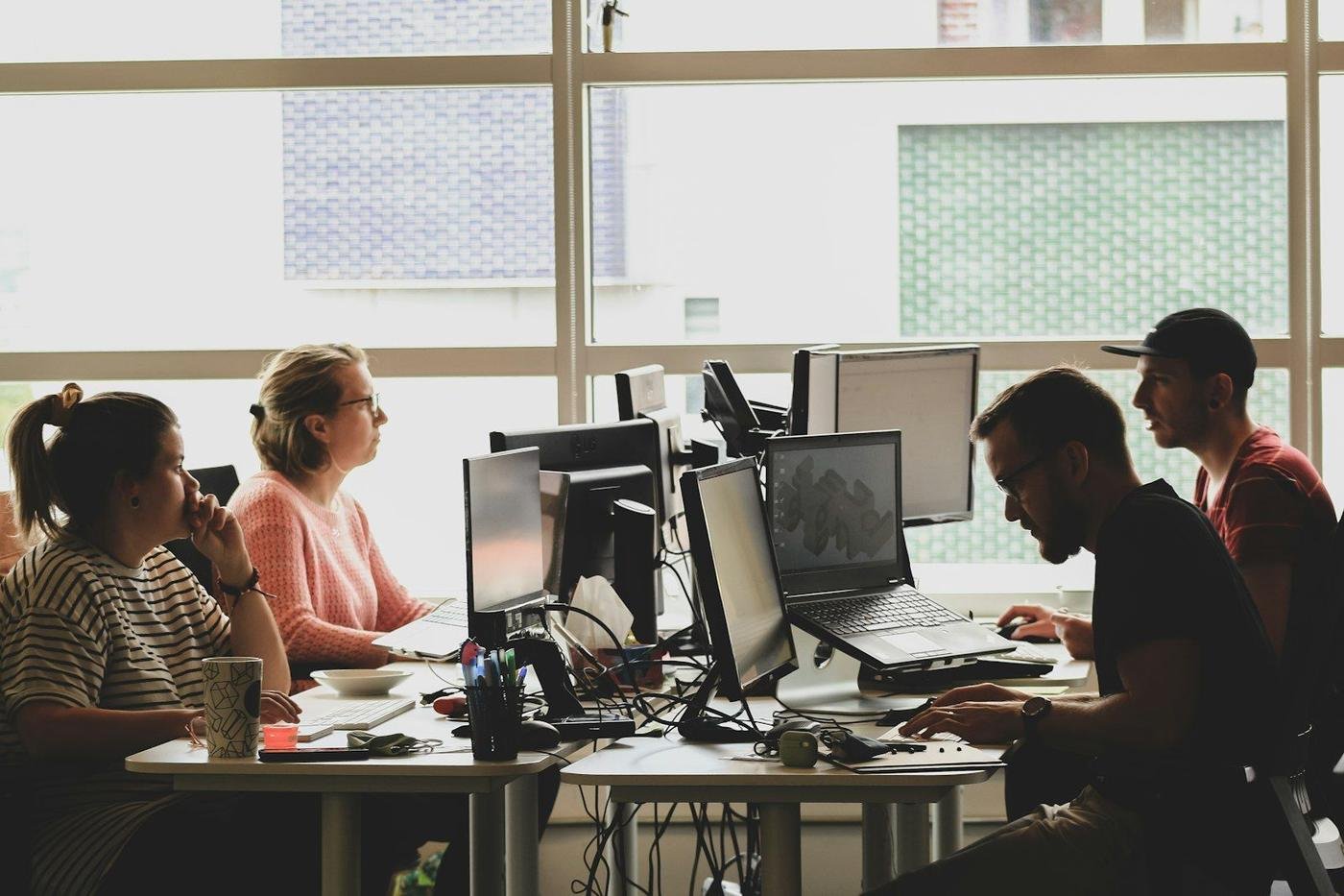 Team working at computers in a sunlit office