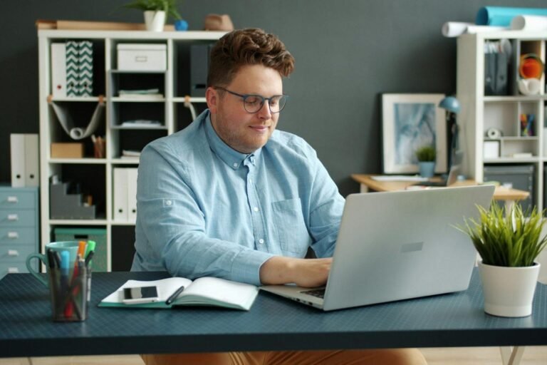Man working on a laptop at a desk in an office