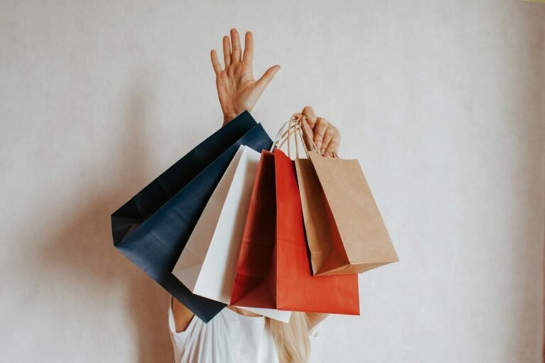 Person holding up several shopping bags