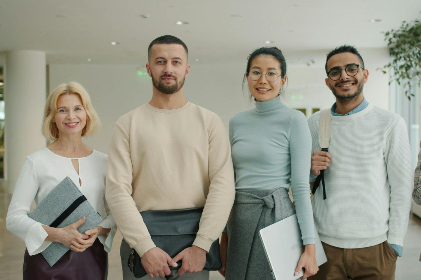 Diverse group of four professionals standing together indoors
