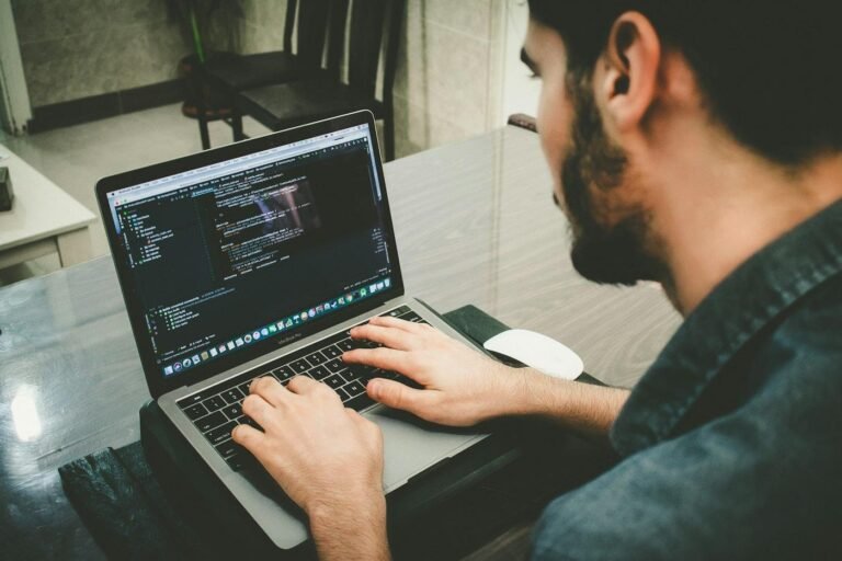 Developer typing code on a laptop