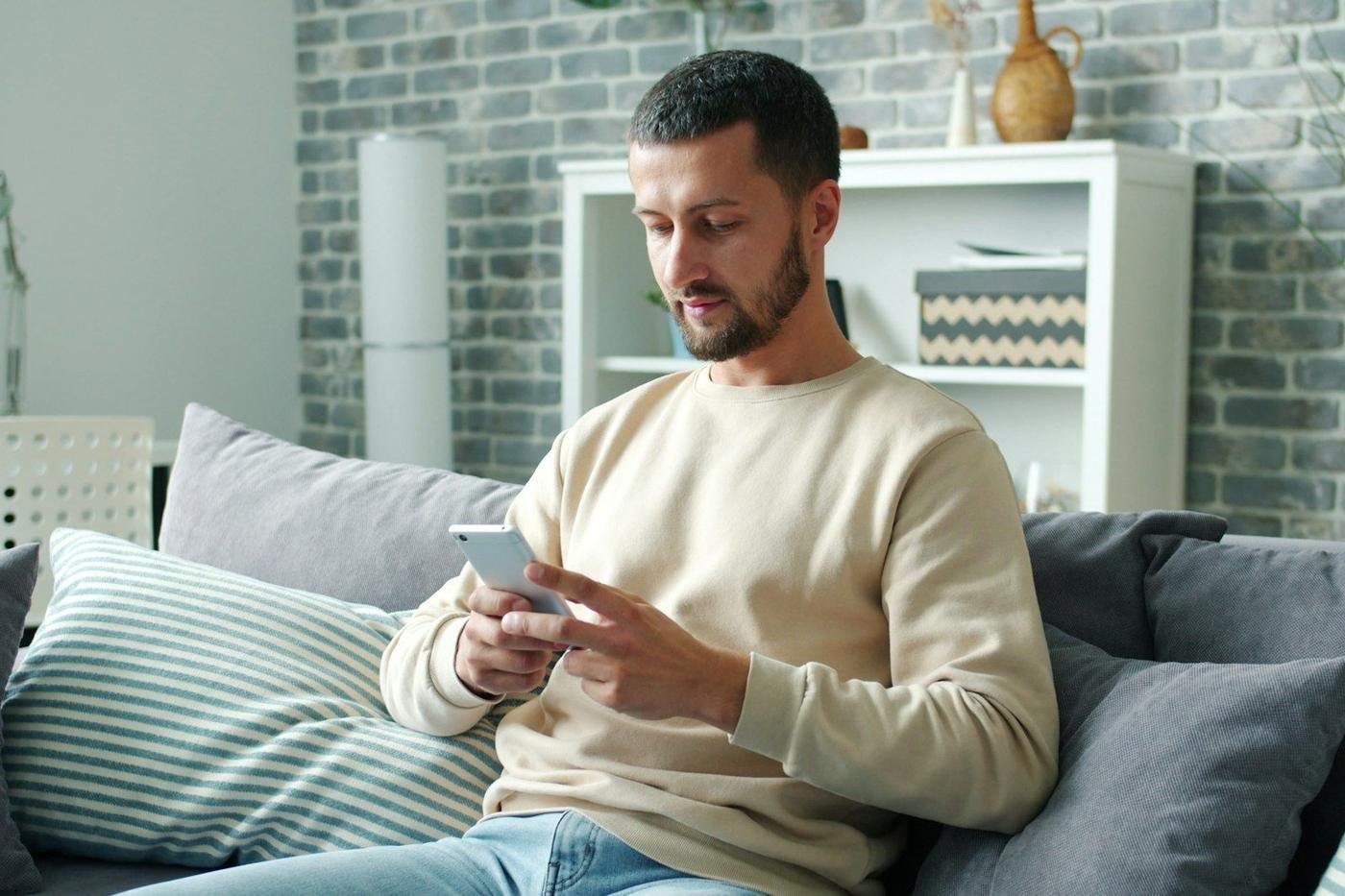 Man on a sofa using a smartphone