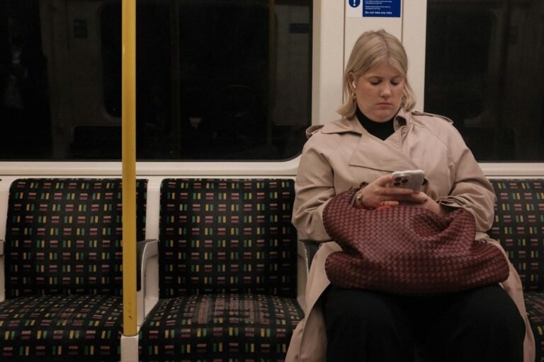 Woman using a smartphone on a subway train