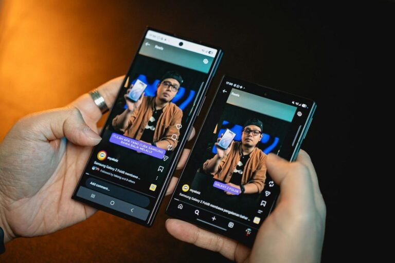 Hands holding two smartphones showing the same app screen