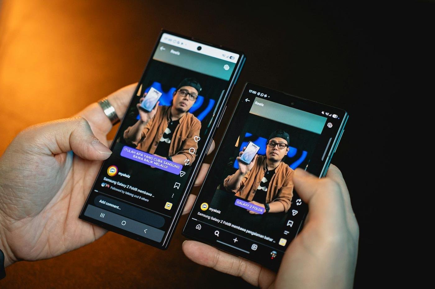 Hands holding two smartphones showing the same app screen